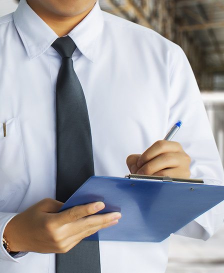 Male engineer inspection writing in factory With note on notepad